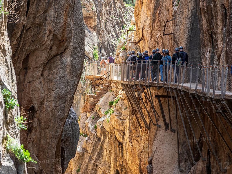 Tourists on the elevated path of the caminito del rey, along a deep gorge, Andalusia, Spain