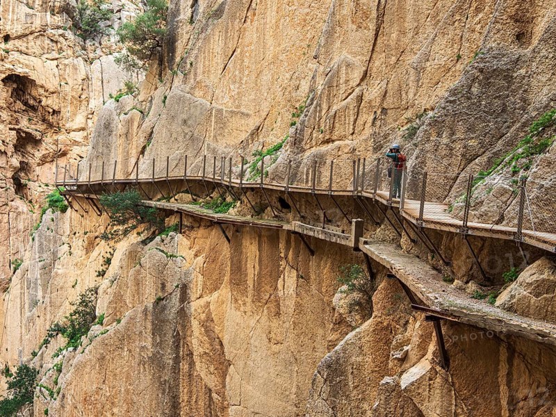 Tourists on the elevated path of the caminito del rey, along a deep gorge, Andalusia, Spain