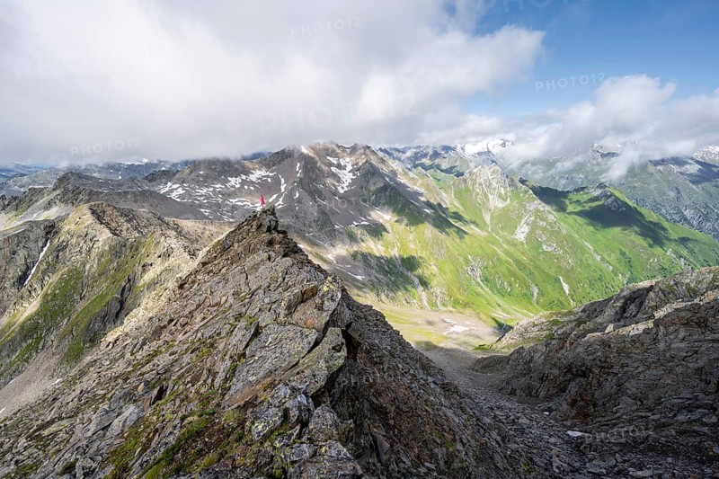 Mountaineer on a steep rocky ridge, on the summit of the Lasörling, view of the mountain panorama of the Venediger Group, Lasörling Group, Hohe Tauern National Park, East Tyrol, Tyrol, Austria