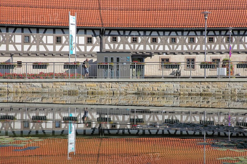 Armoury museum built in 1668 with reflection, half-timbered house, pond, bank, Suhl, Franconia, Thuringia, Germany