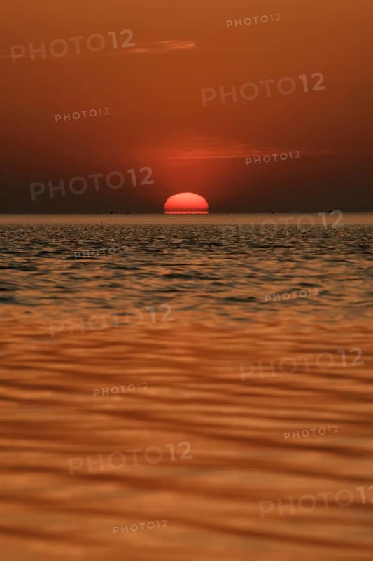 When the red sun sinks into the sea... Cuxhaven, North Sea, sunset in calm weather, glowing red fireball, sun sets fiery red over the sea, sinks into the sea, atmospheric picture, local nature, Lower Saxony Wadden Sea National Park, North Sea near Cuxhaven, Duhnen, Lower Saxony, Germany, Western Europe
