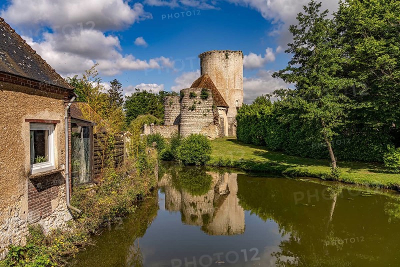 The river Loir and the castle with donjon in Alluyes, Centre-Val de Loire, France