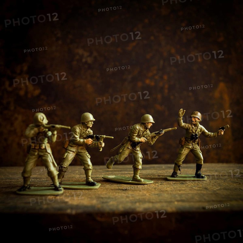 Four toy soldiers stand in various combat stances, ready for action on a weathered wooden surface. The dark background enhances their vintage military theme