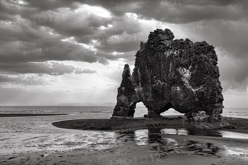 Basalt rock Hvitserkur, famous Elephant Rock on lava beach, coastline, dramatic cloudy sky, rain clouds, monochrome, Vatnsnes Peninsula, Hunafjördur, North Iceland, Iceland