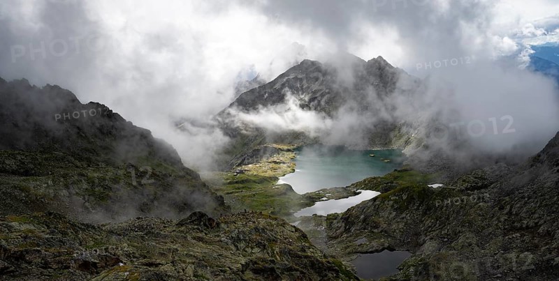 View of mountain landscape with mountain lakes Wangenitzsee and Kreuzsee, cloudy mountain peaks, dramatic atmospheric light, Schober Group, Hohe Tauern National Park, Carinthia, Austria
