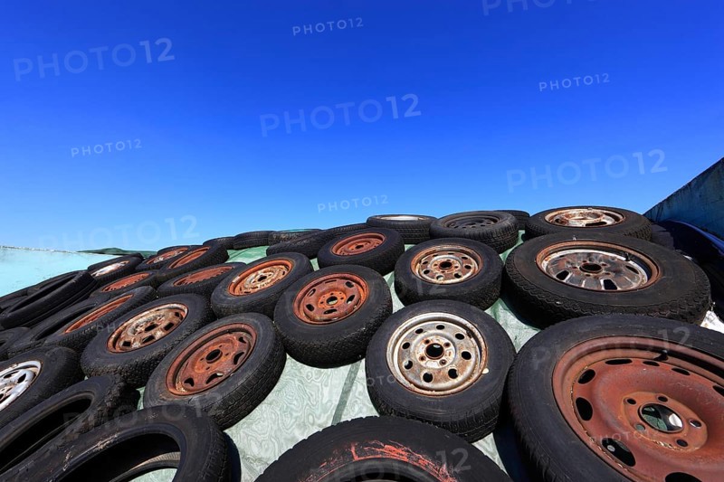 Old wheels, rims and tyres, used here to weigh down the cover of an agricultural silo