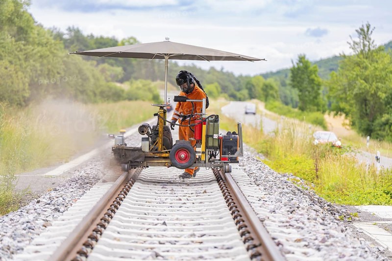A worker carries out welding work with machines on a railway track, grinding work on the Hermann Hesse railway, Ostelsheim, district of Calw, Germany