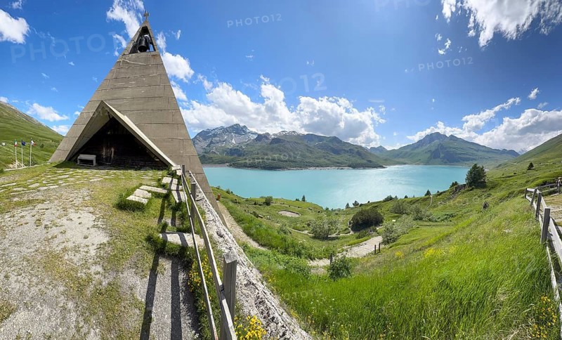 Panoramic photo with Mont-Cenis Pyramid Museum built in 1967 on the left above Lac du Mont Cenis on the right in a stylised pyramid as a museum to commemorate the Egyptian campaigns of Emperor Napoleon Bonaparte and the time in front of the construction of the reservoir, Mont Cenis massif, Massif du Mont-Cenis, Graian Alps, Lanslebourg, Rhone-Alpes, France