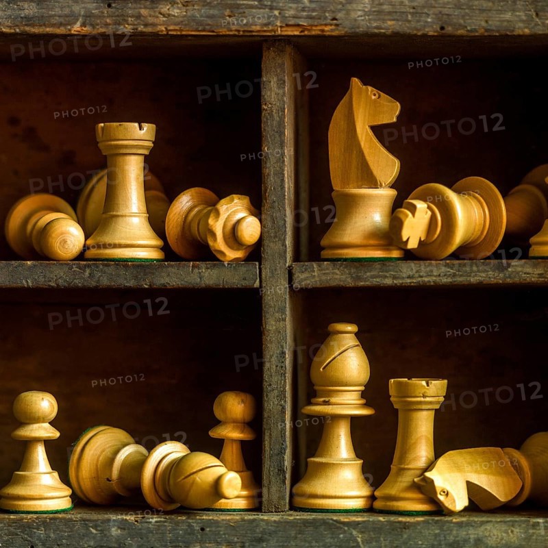 Wooden chess pieces arranged in a vintage box showcasing strategic game elements and craftsmanship