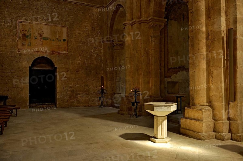 Baptismal font, remains of 14th century frescoes, side chapel, interior, Gothic basilica of the Cistercian abbey of Fossanova Monastery, Cistercian-Burgundian architectural style, Priverno, Province of Latina, Lazio, Italy