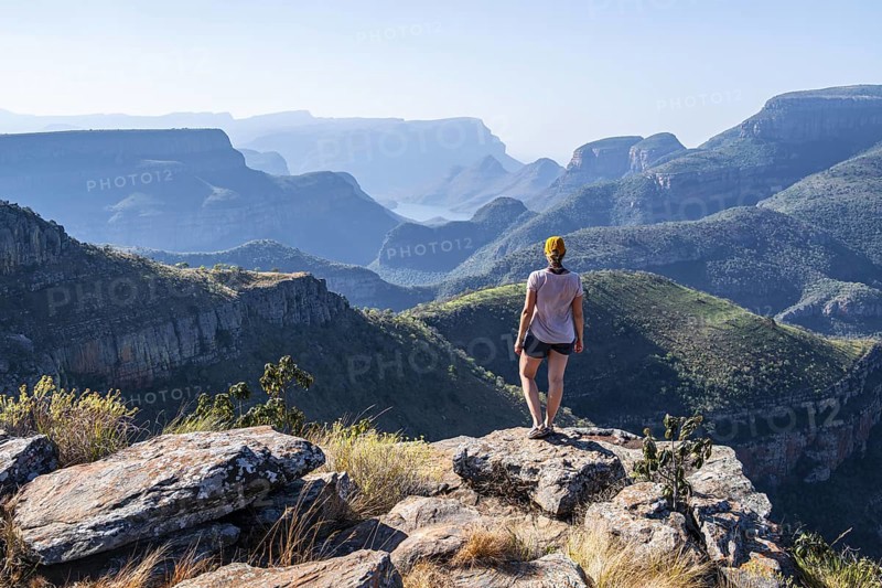 Tourist looking over canyon landscape, view of Blyde River gorge, Lowveld Viewpoint, in the evening light, Blyde River Canyon, Panorama Route, Mpumalanga, South Africa