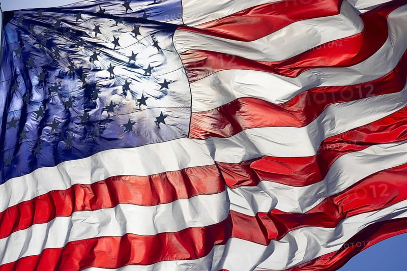 Dramatic backlit american flag waving in the wind