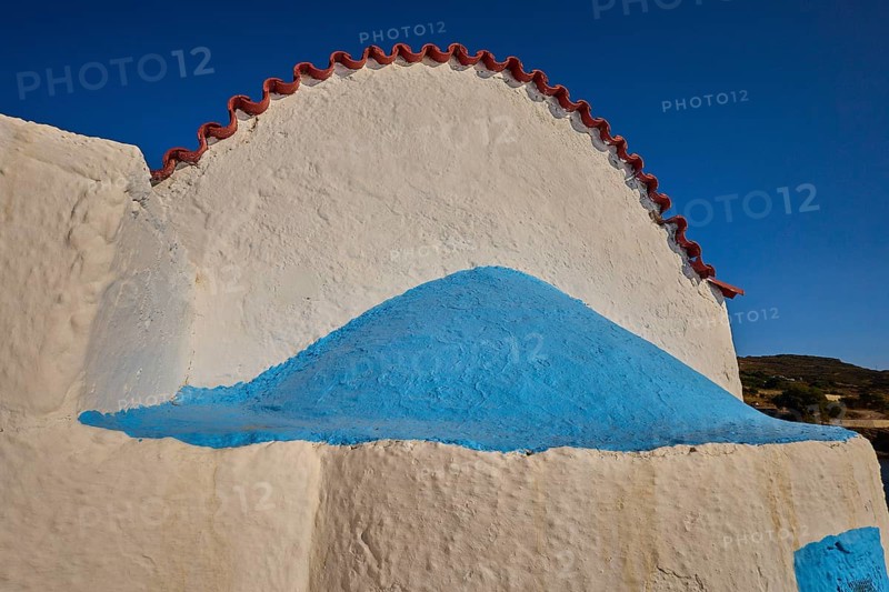 Close-up of a white church vault with blue accents under a blue sky, chapel, church, Agios Isidoros, rocky islet, Gourna Bay, Kokkali, Leros, Dodecanese, Greek Islands, Greece