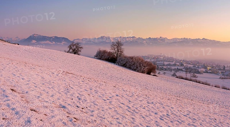 Village in the fog and in the light of dusk, behind the Rigi, Hohenrain, Seetal, Canton Lucerne, Switzerland