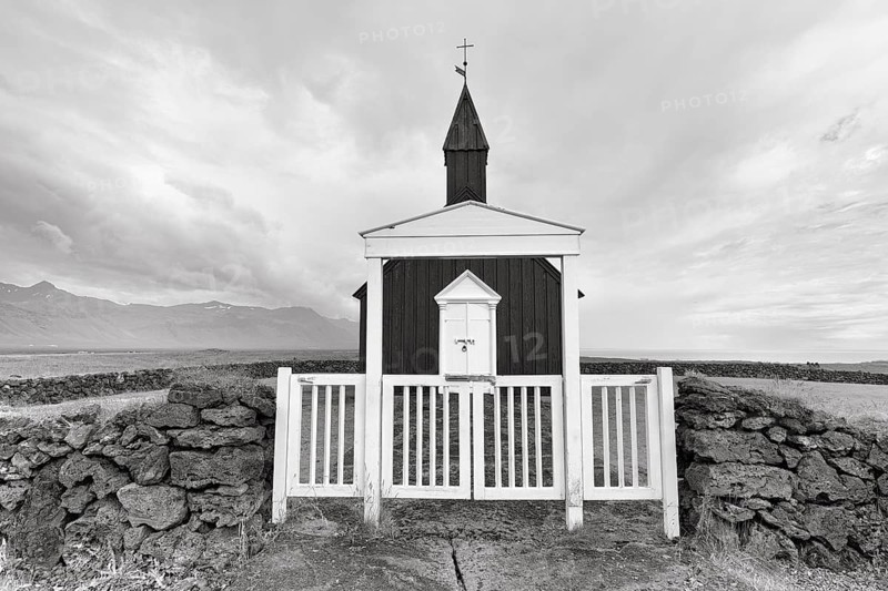 Traditional black church with white wooden door and stone wall, wooden church Budakirkja, monochrome, Búðir, Budir, Snaefellsnes Peninsula, Iceland