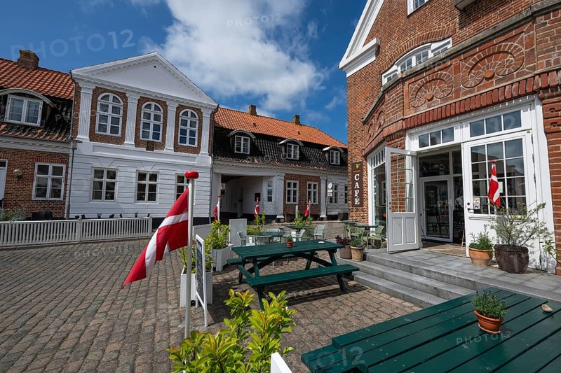 Cosy café with Danish flags and inviting terrace under a blue sky, Old Town, Ringkøbing, Ringkøbing Fjord, Denmark