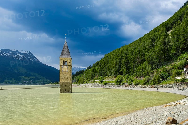 Bell tower of the former parish church of St Catherine in the sunken village of Alt-Graun in Lake Reschen in Vinschgau, South Tyrol, Italy