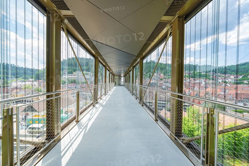 A modern, light-flooded glass corridor with a view of the urban surroundings, Zob extension with bridge construction for the new Herman Hesse railway, Calw, Black Forest, Germany