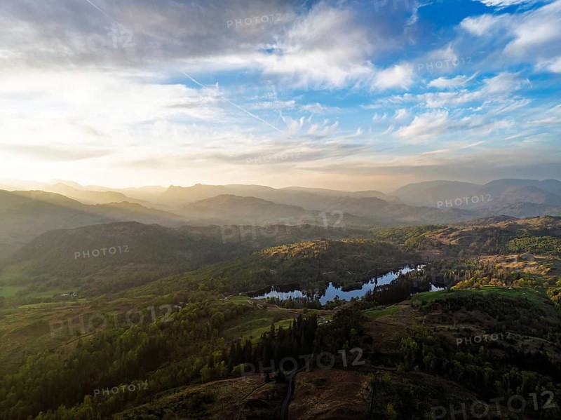 Sunset over Mountains and Coniston Water from drone, Lake District National Park, Cumbria, England, United Kingdom