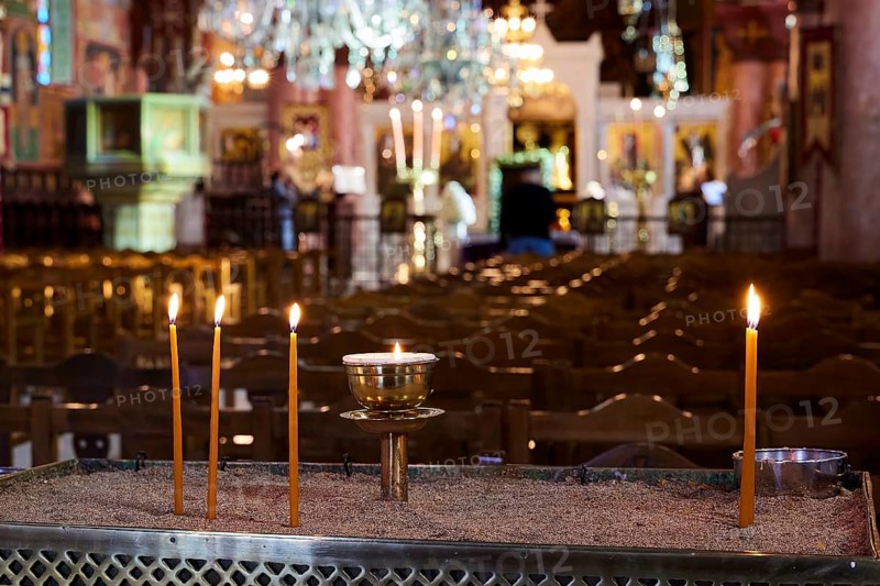 Burning candles on a sand container in an illuminated church with blurred surroundings, Church of the Annunciation of the Blessed Virgin Mary, Rhodes Town, Greece, Orthodox Church, Dodecanese, Greek Islands, Rhodes Town, Holy Week, Rhodes