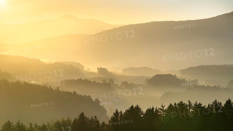 Landscape with forest, meadows and mountains around the town of Bad Kötzting, with a part of the Kaitersberg in the background on the right. In the morning at sunrise. District of Cham, Upper Palatinate, Bavarian Forest, Bavaria, Germany