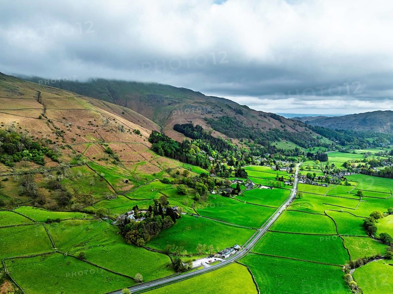 Farms and Mountains over road A591 from a drone, Grasmere Lake, Grasmere, Ambleside, Lake District, Westmorland, Cumbria, UK