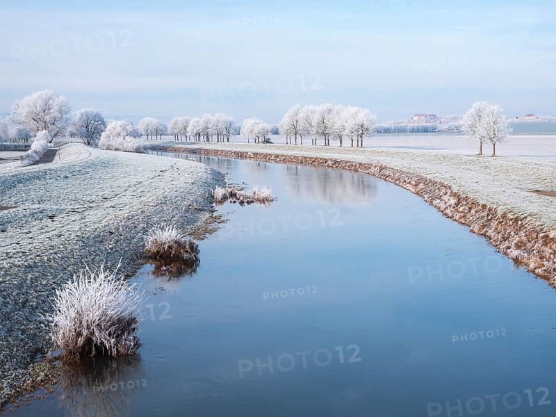 The river Unstrut in the Unstrut valley in winter, fields and trees covered with hoarfrost, behind Wendelstein Castle, Memleben, Saxony-Anhalt, Germany