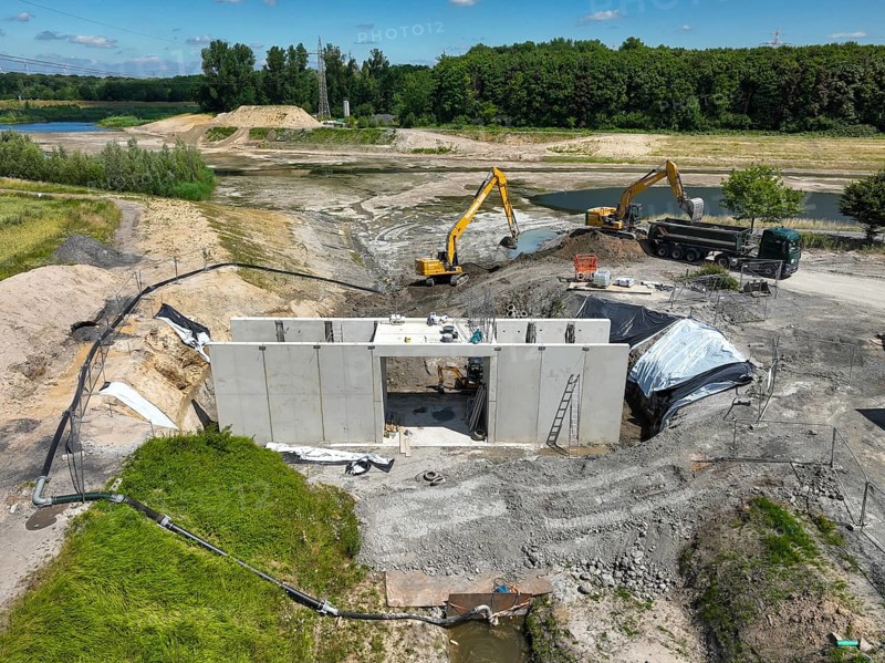 Dortmund, Castrop-Rauxel, North Rhine-Westphalia, Germany - River renaturalisation, renaturation of the Emscher, flood retention basin HRB Mengede. Heimanngraben intake in front, construction of a bridge over the ditch. A new floodplain landscape is being created at the Emscher-Auen farm, expansion of the area for flood protection during heavy rainfall and for biodiversity. The previously straightened Emscher is given curves again and can meander through its new floodplain. Following the construction of a parallel sewer, the Emscher has been completely free of sewage since 2022. The river was previously an open, above-ground combined sewer with rainwater and wastewater