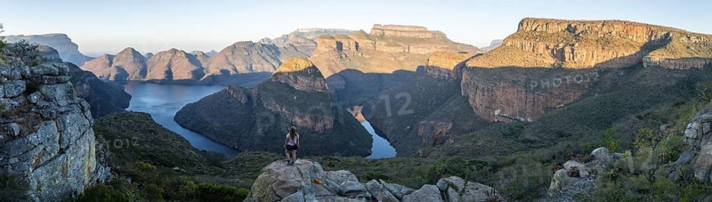 Hiker enjoying panorama, sunset at Blyde River Canyon with Three Rondawels peak, view of canyon with Blyde River and table mountains in the evening light, canyon landscape, Panorama Route, Mpumalanga, South Africa