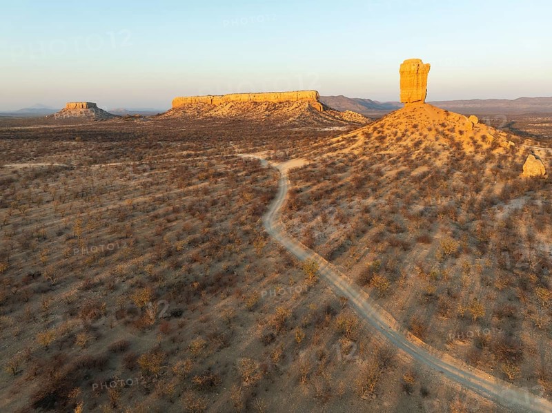 The Vingerklip (rock finger) and the Ugab Valley Terraces are surrounded by thornbush and mopane (Colophospermum mopane) savanna. Aerial view. Drone shot. Damaraland, Namibia