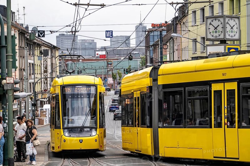 Ruhrbahn tram, on Altendorfer Straße, intersection Helenenstraße, in Essen-Altendorf, rush hour, traffic, skyline of the city centre of Essen, North Rhine-Westphalia, Germany