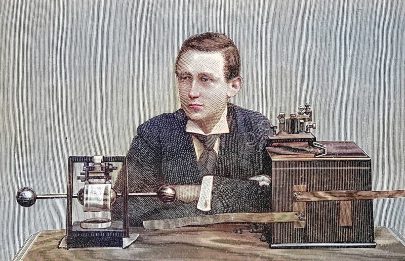 Marconi and his telegraph apparatus. Guglielmo (since 1924 Marchese) Marconi (1874-1937) was an Italian researcher, entrepreneur and pioneer of wireless telecommunication, coloured wood engraving, reproduction of a model from ca 1888, historical, man in suit with historical equipment on a table