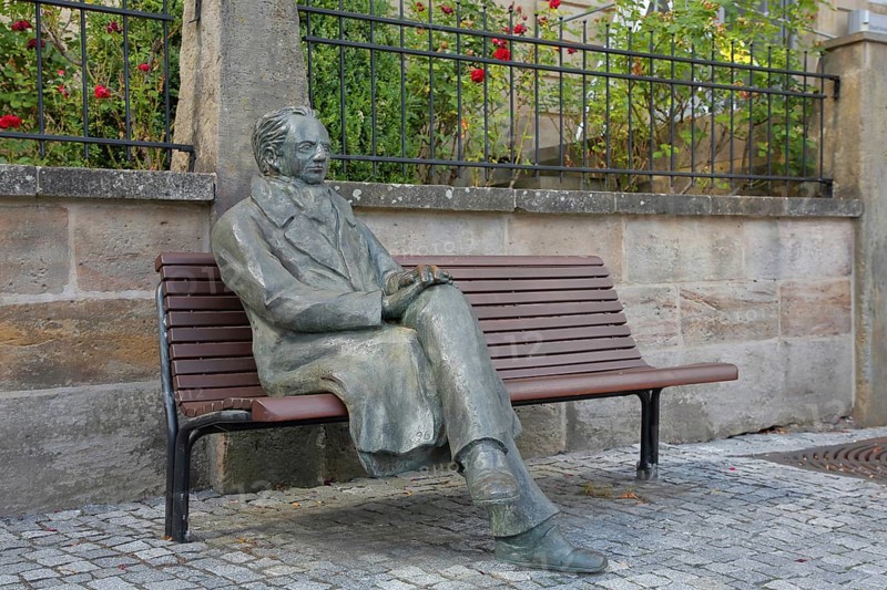 Johann Wolfgang von Goethe by Klaus Gutting sitting on the bench, bronze sculpture, looking, arms, monument, modern art, GoetheStadtMuseum, Amtshaus, market square, Ilmenau, Thuringian Forest, Thuringia, Germany