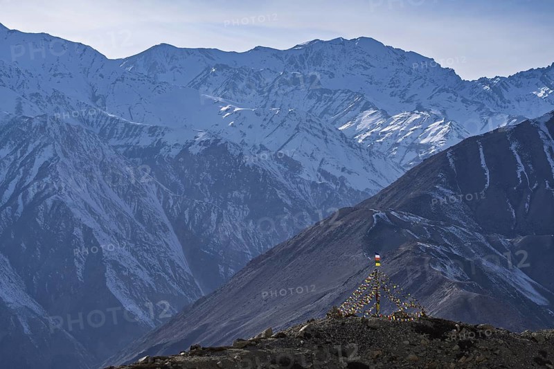 View of the Himalayan mountains, Buddhist prayer flags in the foreground, Himalayas, Hangrang, Himachal Pradesh, India