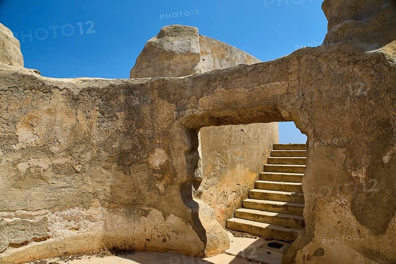 Entrance to ruined structure with stairs and blue sky, Lost Place, Air Defence Position, Aerophone, Parabolic Acoustic Mirror, Patella Mountain, WW2, west of Lakki, Leros, Dodecanese, Greek Islands, Greece