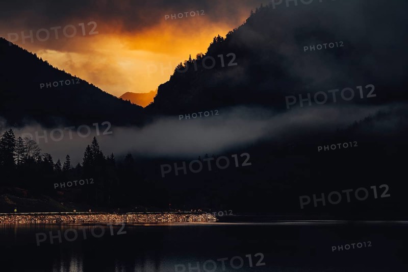 Surreal light atmosphere at sunrise at Plansee, Tyrol, in the Alps in Austria