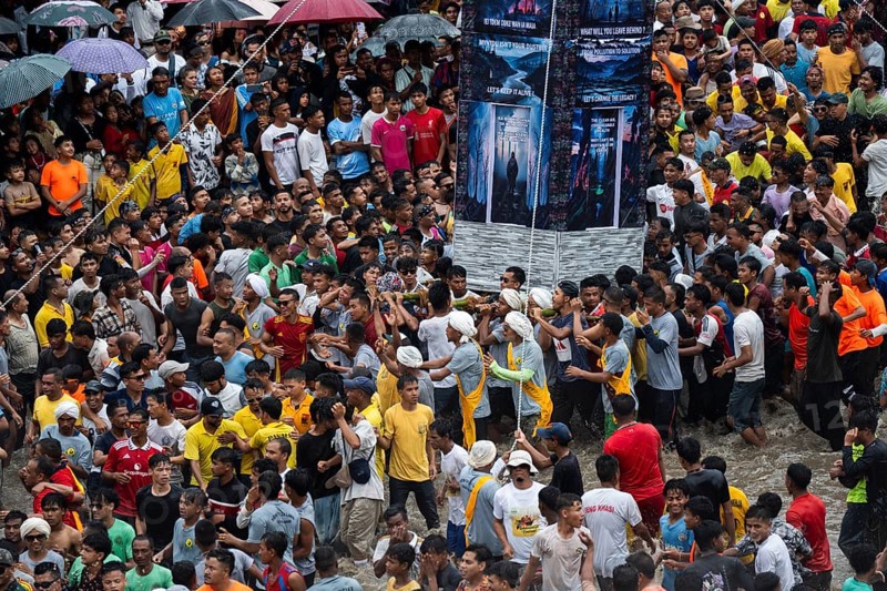 JOWAI, INDIA - JULY 14: People from the Pnar community march in a circle around a Rot as they celebrate an event organised to mark the Behdienkhlam festival in Jowai, India on July 14, 2025. Behdienkhlam is a vibrant annual festival celebrated by the Pnar (Jaintia) community of Meghalaya, especially in Jowai, to drive away plague and diseases and to pray for a good harvest. Observed in July after the sowing season, it features traditional rituals, offerings to ancestral spirits, and the grand procession of beautifully decorated bamboo structures called rots, which are later immersed in a sacred muddy pool known as Ka Aitnar