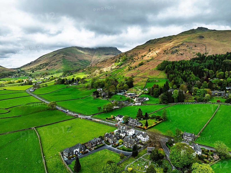Farms and Mountains over road A591 from a drone, Grasmere Lake, Grasmere, Ambleside, Lake District, Westmorland, Cumbria, UK