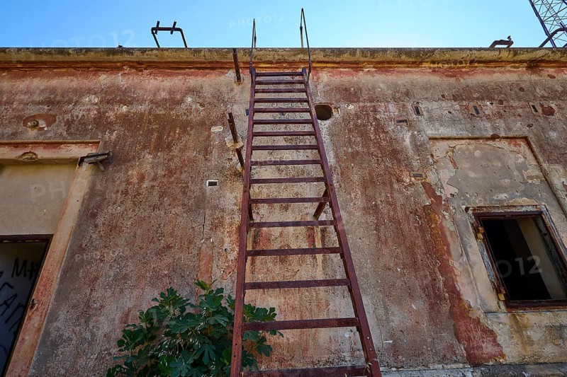Lost Place, Dilapidated building with rusty metal ladder attached to the facade, Radio Station, WW2, Agios Nikolaos Radio, Agia Marina, Leros, Dodecanese, Greek Islands, Greece