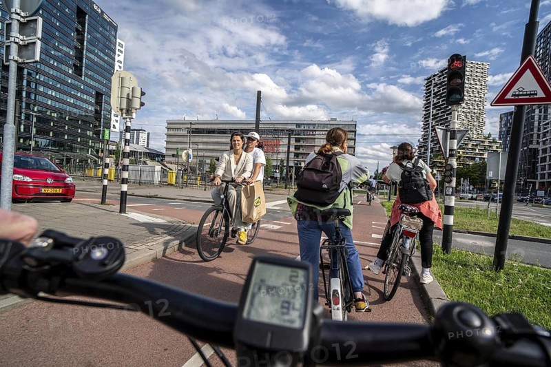 Cycle along the Jaarbeursplein, south of Utrecht Central, HBF, on the central cycle path in the city centre of Utrecht, lanes for pedestrians, cyclists and vehicles are separated, heavy cycle traffic, Netherlands