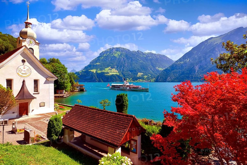 Steamboat on Lake Uri, Roman Catholic church in the village of Bauen, Fronalpstock mountain behind, cantons of Uri and Schwyz, Switzerland