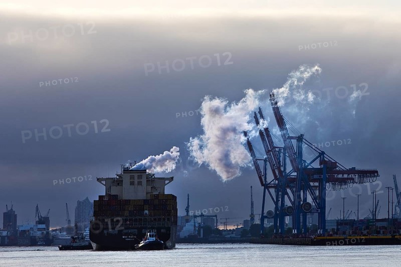 Container ship MSC Tokyo with two small tugs near the Burchardkai container terminal in the Port of Hamburg, Germany