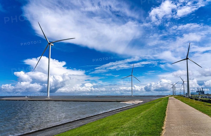 Strekdammen Wind Farm, wind farm at the seaport of Eemshaven in the Netherlands, left, built on offshore breakwaters, 2 GE Cypress 5, 5 MW turbines, with 158 metre blade diameter, together produce 11 MW of power, can supply 15, 500 households with electricity from wind, cumulus cloud over the North Sea, Netherlands