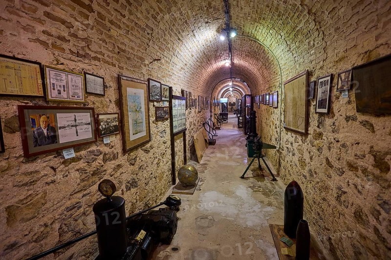 Long tunnel room with paintings and exhibits on the walls, War Museum, Military Museum, Tunnel Museum, Lakki, Leros, WW2, Dodecanese, Greek Islands, Greece