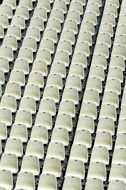 Empty stadium seats arranged in neat rows highlight the readiness for an upcoming sports event or concert