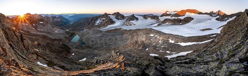 Panorama at sunrise with sun star, high mountain landscape, view of blue glacial lakes, mountain peaks Königshofspitz and Hofmannspitze with glacier of the Übeltalferner, Stubai Alps, South Tyrol, Italy