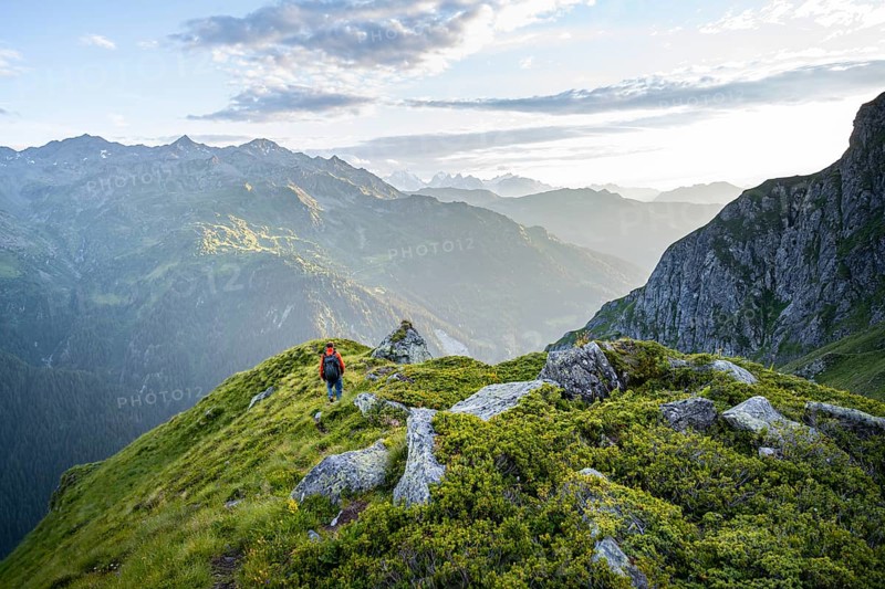 Mountaineers in a picturesque mountain landscape in the atmospheric evening light, view from the Cabane du Louvie, Valais Alps, Val de Bagnes, Valais, Switzerland