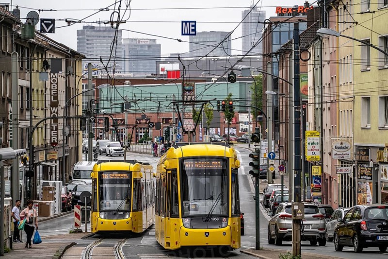 Ruhrbahn tram, on Altendorfer Straße, intersection Helenenstraße, in Essen-Altendorf, rush hour, traffic, skyline of the city centre of Essen, North Rhine-Westphalia, Germany