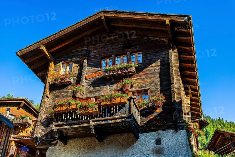Old wooden house in log construction, decorated with flowers, historic village centre, Grimentz, Val d'Anniviers, Valais Alps, Canton Valais, Switzerland