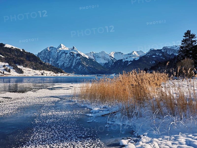 Frozen Sihlsee, reservoir, behind the snow-covered mountains Flübrig and Druesberg, Euthal, Canton Schwyz, Switzerland